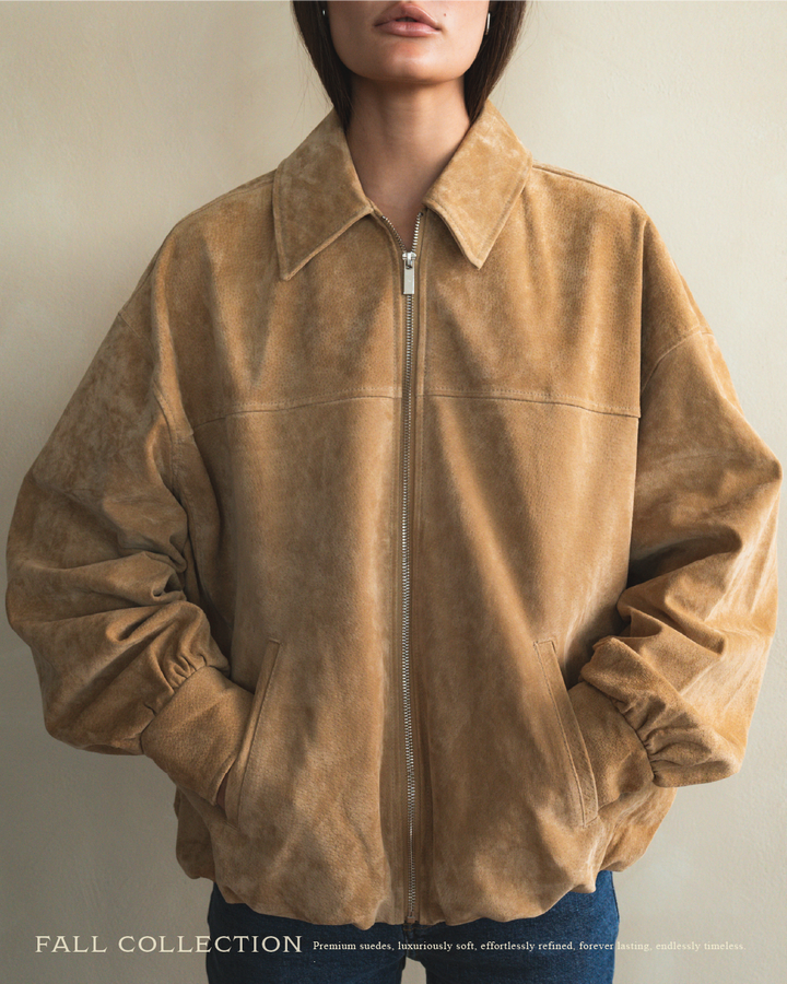 Brown suede jacket worn by a person on a plain background